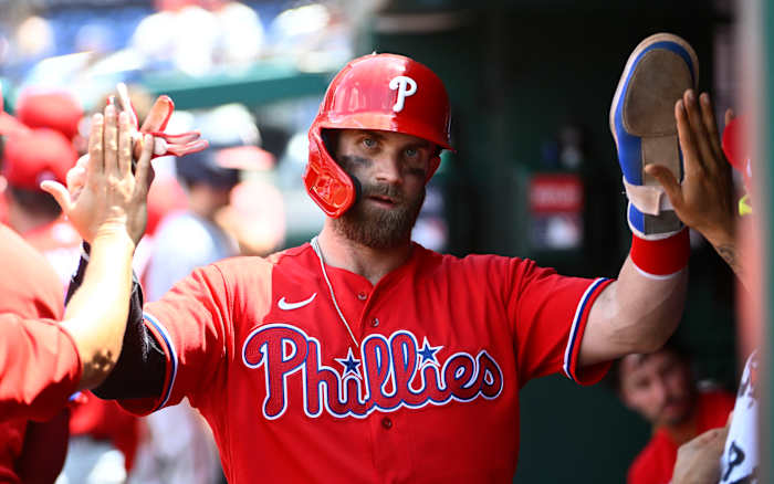 Bryce Harper celebrates with teammates after scoring a run against the Washington Nationals.